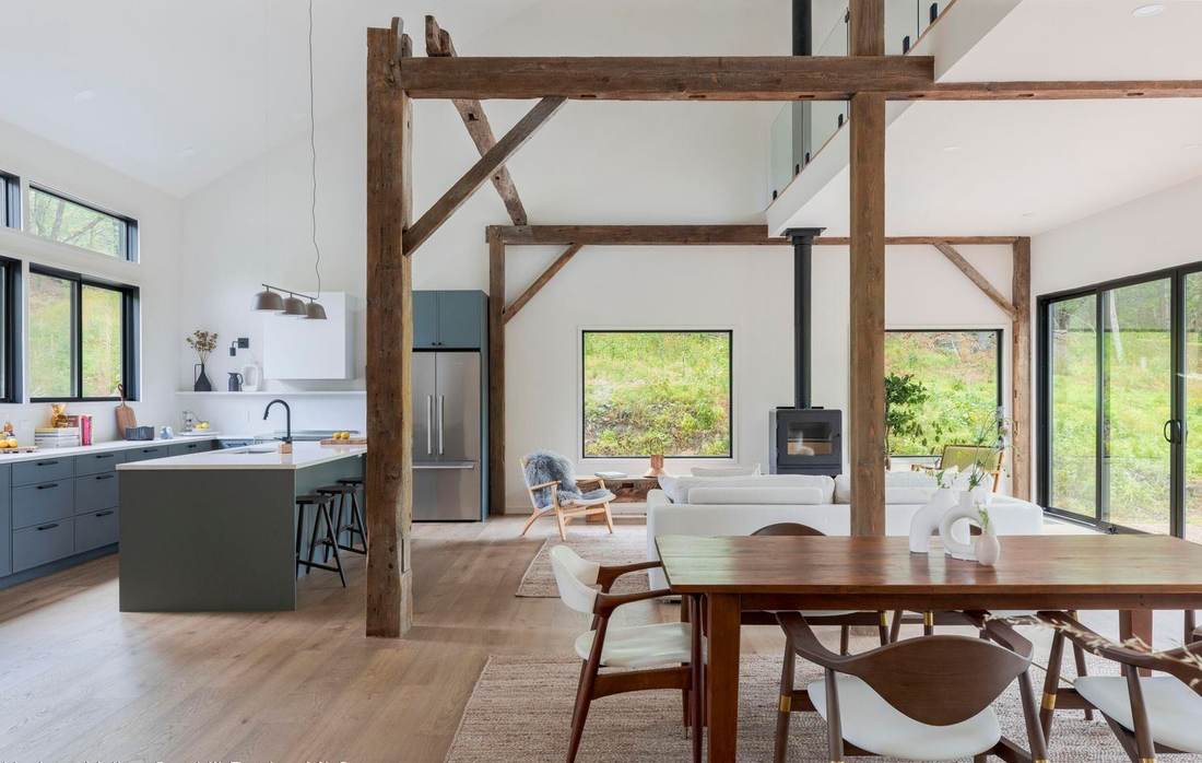 Open living and dining area in a Capella Studios home with reclaimed hand-hewn barn beams